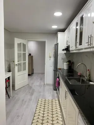 a kitchen with white cabinets and a counter top at Luxury Apartment in City Center of Marrakech in Marrakech