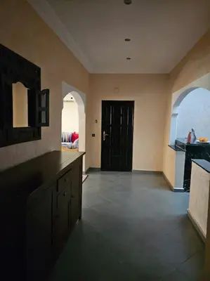 a large room with a kitchen with a black door at Appt 10min pied jardin Majorelle in Marrakech