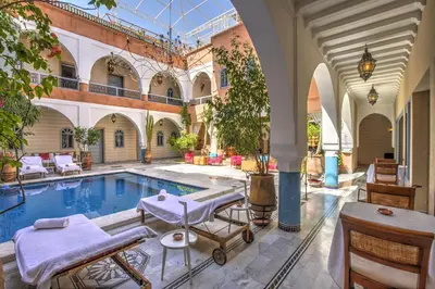 an indoor pool with a massage table in a building at Ksar Anika Boutique Hotel & Spa in Marrakech
