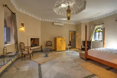 a bedroom with a bed and a chandelier at Ksar Anika Boutique Hotel & Spa in Marrakech