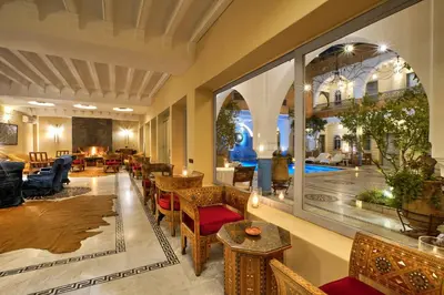 a lobby of a hotel with tables and chairs at Ksar Anika Boutique Hotel & Spa in Marrakech