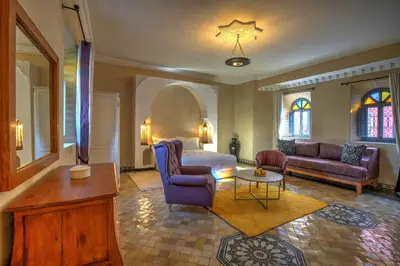 a living room with a bed and a couch and a table at Ksar Anika Boutique Hotel & Spa in Marrakech