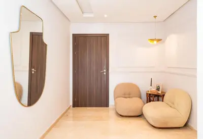 a room with two chairs and a mirror at Luxury and Healthy designed Apartment with pool in Marrakech
