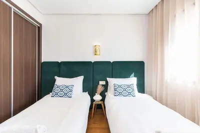 two beds sitting next to each other in a bedroom at Luxury and Healthy designed Apartment with pool in Marrakech