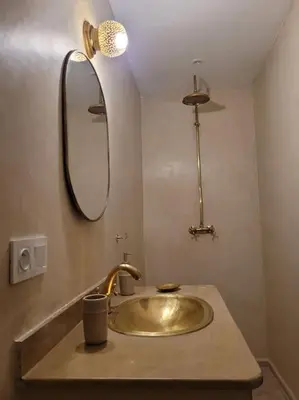 a bathroom with a gold sink and a mirror at Dar Amazigh mit 3 Schlafzimmern in Marrakech