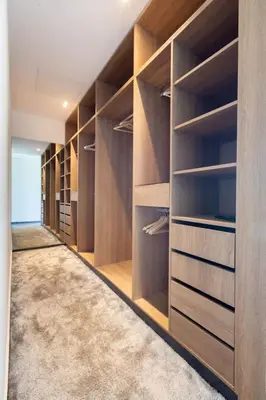 a walk in closet with wooden shelves and a carpet at Villa Relax in Marrakech