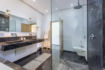 a bathroom with a shower and a sink and a toilet at Villa Relax in Marrakech