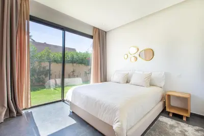 a bedroom with a bed and a large window at Villa Relax in Marrakech