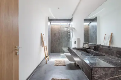 a bathroom with a large marble sink and a shower at Villa Relax in Marrakech