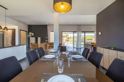 a dining room with a long table and chairs at Villa Relax in Marrakech