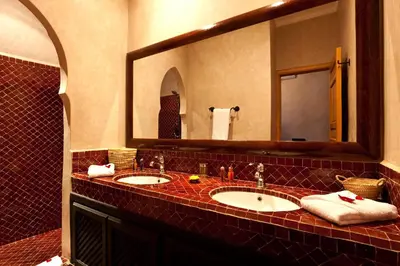 a bathroom with two sinks and a large mirror at Hotel & Spa Riad El Walaa in Marrakech