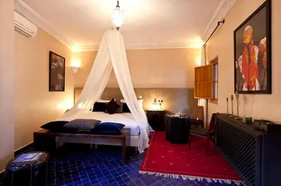 a bedroom with a bed with a canopy at Hotel & Spa Riad El Walaa in Marrakech