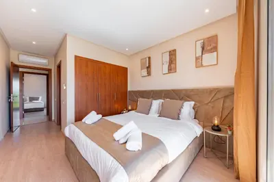 a bedroom with a large bed with white pillows at Cute And Modern Appart In Prestigia in Marrakech