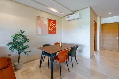 a dining room with a wooden table and chairs at 2Bedrooms In Prestigia - Very Well Equipped With View in Marrakech