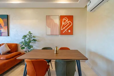 a dining room with a wooden table and chairs at 2Bedrooms In Prestigia - Very Well Equipped With View in Marrakech