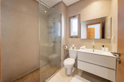 a bathroom with a toilet and a glass shower at 2Bedrooms In Prestigia - Very Well Equipped With View in Marrakech