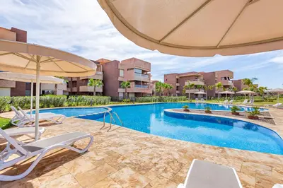 an image of a swimming pool with chairs and an umbrella at 2Bedrooms In Prestigia - Very Well Equipped With View in Marrakech