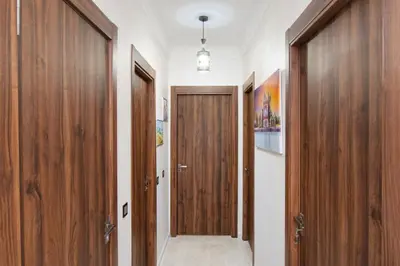 a hallway with wooden doors in a house at Appartement Piscine & Parking in Marrakech