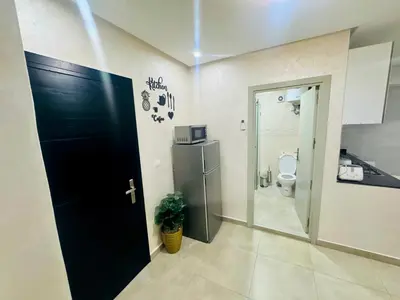 a bathroom with a black door and a toilet at Résidence Miramas 2 - C5 in Marrakech