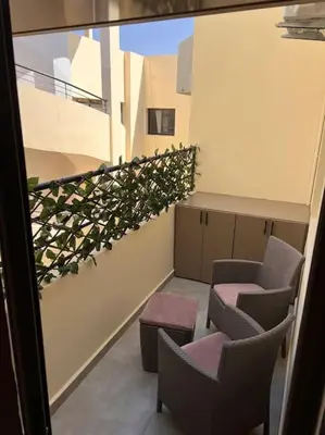 a balcony with chairs and plants on a building at Résidence Miramas 2 - C5 in Marrakech