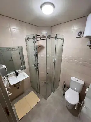 a bathroom with a shower and a toilet and a sink at Résidence Miramas 2 - C5 in Marrakech
