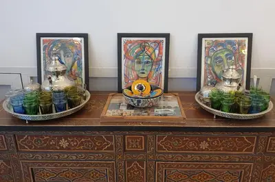 a table with three vases and a bowl of fruit on it at Riad LakLak Nouvelle 400m2 mit Pool in der Medina in Marrakech