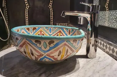 a mosaic sink in a bathroom with a faucet at Riad LakLak Nouvelle 400m2 mit Pool in der Medina in Marrakech