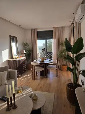 a living room with a couch and a table at Dar Ou Bahssou in Marrakech