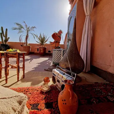a living room with vases and a table and a room with at Dar Ou Bahssou in Marrakech