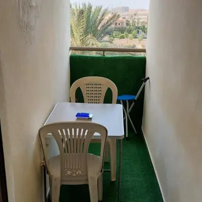 a table and chairs in a room with a window at Marrakech Apart Macdonald Rte safi 10 min gueliz in Marrakech