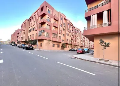 an empty street with cars parked on the side of a building at Marrakech Apart Macdonald Rte safi 10 min gueliz in Marrakech