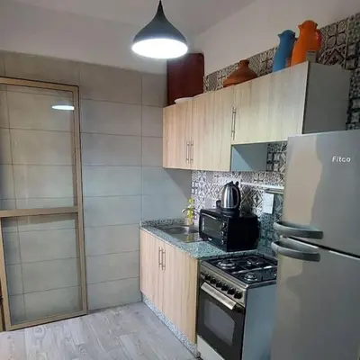 a kitchen with a stove and a refrigerator at Marrakech Apart Macdonald Rte safi 10 min gueliz in Marrakech
