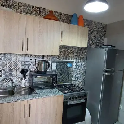 a kitchen with a stove and a refrigerator at Marrakech Apart Macdonald Rte safi 10 min gueliz in Marrakech