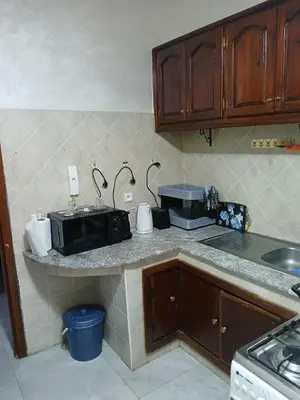 a kitchen with a counter with a microwave on it at AC Family apartment steps away from everything in Marrakech