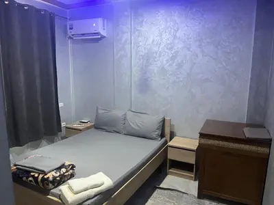 a small room with a bed and a desk at AC Family apartment steps away from everything in Marrakech