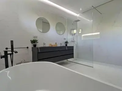a white bathroom with a sink and a mirror at Villa Léna détente en famille ! in Marrakech