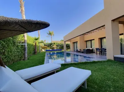 a backyard with a swimming pool and a resort at Villa Léna détente en famille ! in Marrakech