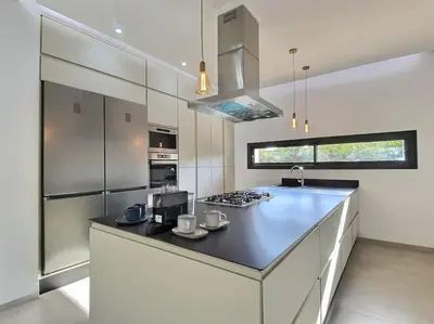 a kitchen with a counter with a stove top oven at Villa Léna détente en famille ! in Marrakech