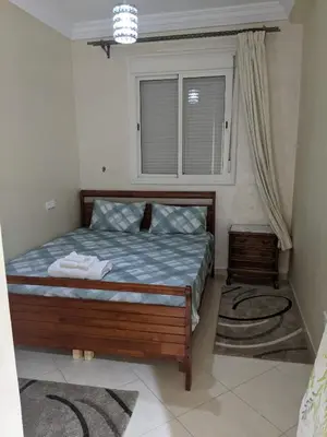 a bed in a room with a window and a bed sidx sidx sidx at Marrakech apartment in Marrakech