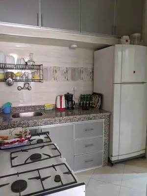 a kitchen with a stove and a white refrigerator at Marrakech apartment in Marrakech