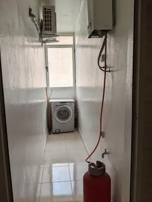 a small room with a washing machine and a window at Marrakech apartment in Marrakech