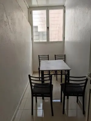 a table and chairs in a room with a window at Marrakech apartment in Marrakech