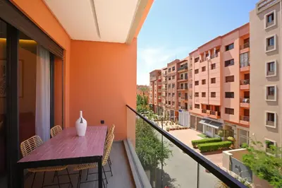 a balcony with a table with a vase on it at Brand New and Stylish appart hotel Best location in Marrakech