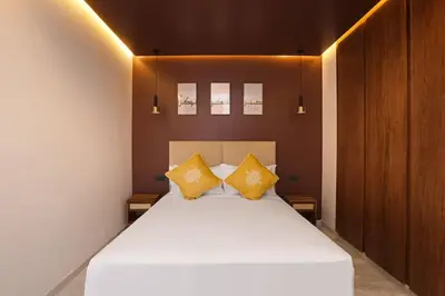 a bedroom with a bed with two yellow pillows at Brand New and Stylish appart hotel Best location in Marrakech