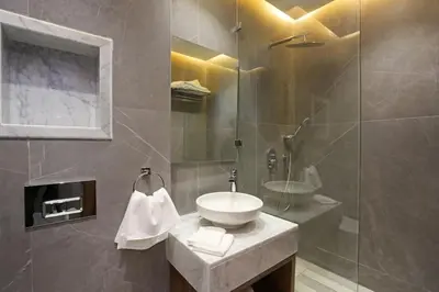 a bathroom with a sink and a glass shower at Brand New and Stylish appart hotel Best location in Marrakech