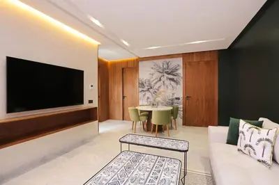 a living room with a couch and a tv at Brand New and Stylish appart hotel Best location in Marrakech