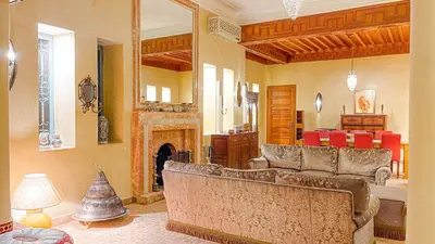 a living room with a couch and a fireplace at Villa des Rêves in Marrakech
