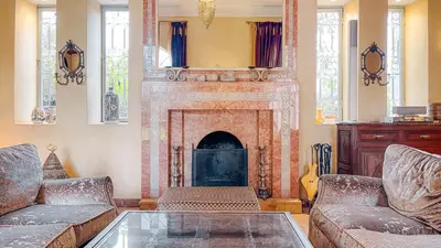 a living room with two couches and a fireplace at Villa des Rêves in Marrakech
