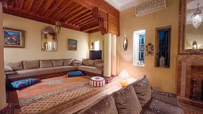 a living room with a couch and a fireplace at Villa des Rêves in Marrakech