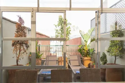 a patio with tables and chairs and potted plants at Riad Dar Habiba 120m2 in der Medina mit Terrasse in Marrakech